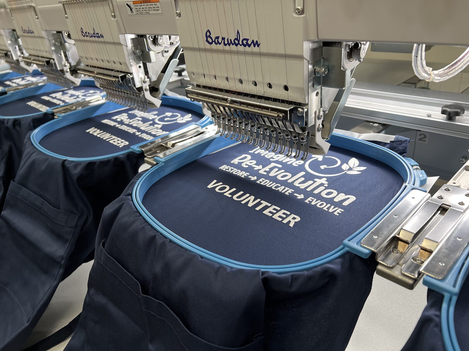 Navy volunteer aprons being embroidered on Embrand's multi-head machine.